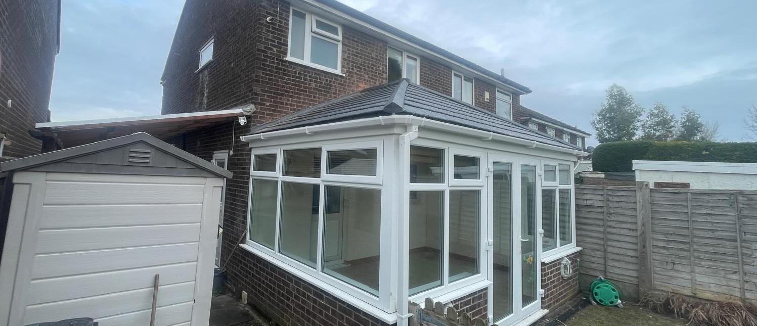 Conservatory tiled roof replacement Stockport SK7 — exterior view showing new grey tiles